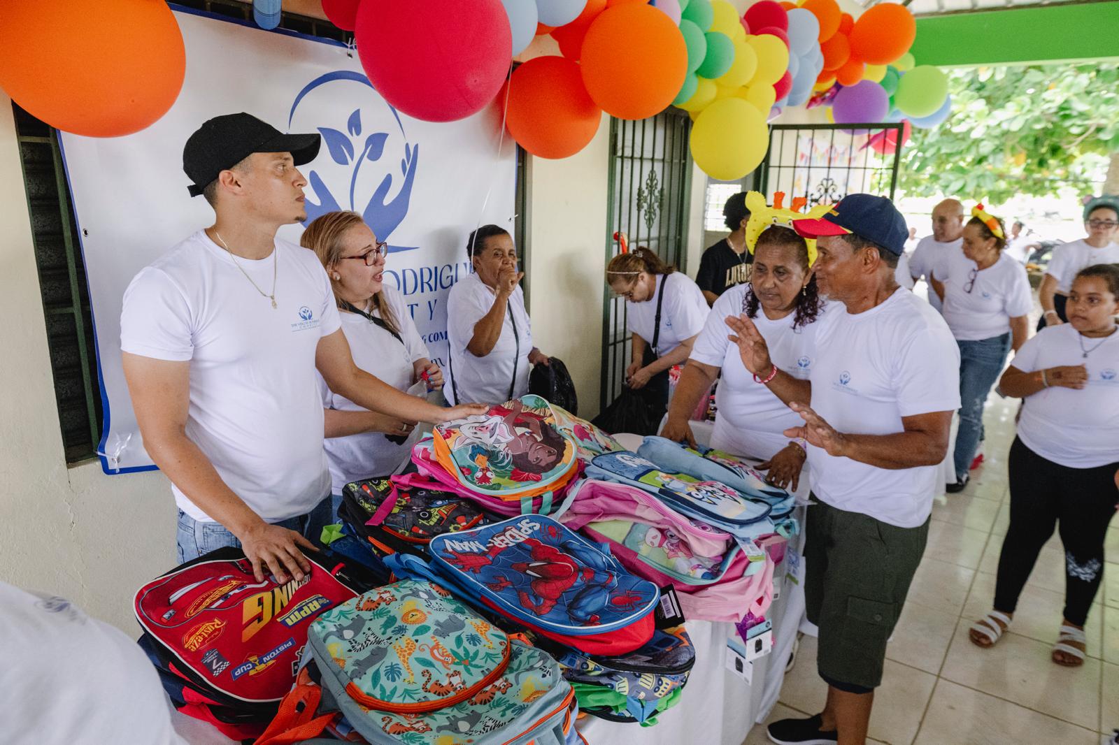 Backpacks and school supplies laid out for distribution