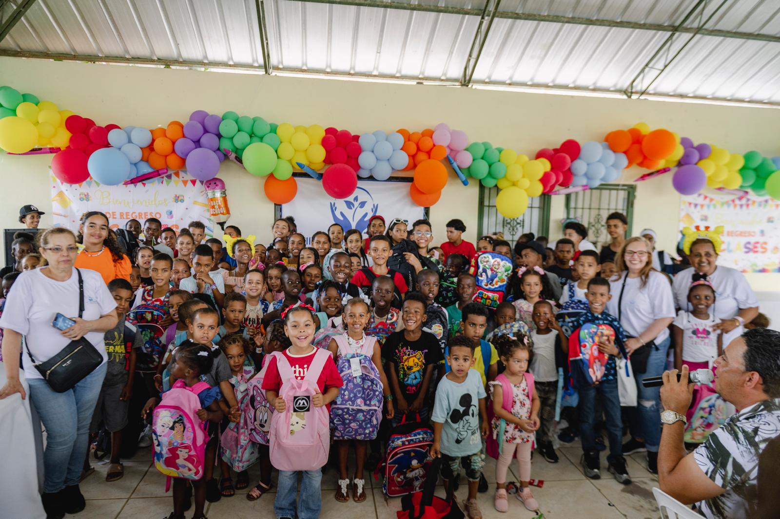 Children holding backpacks at a VelRod Back-to-School event