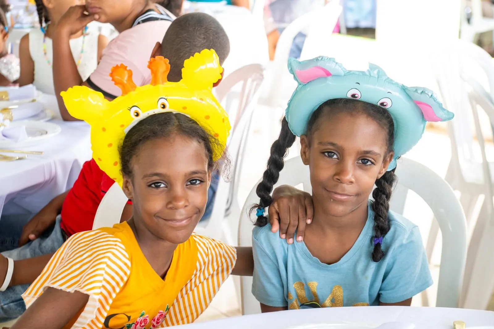 Two girls in animal balloon hats at the celebration