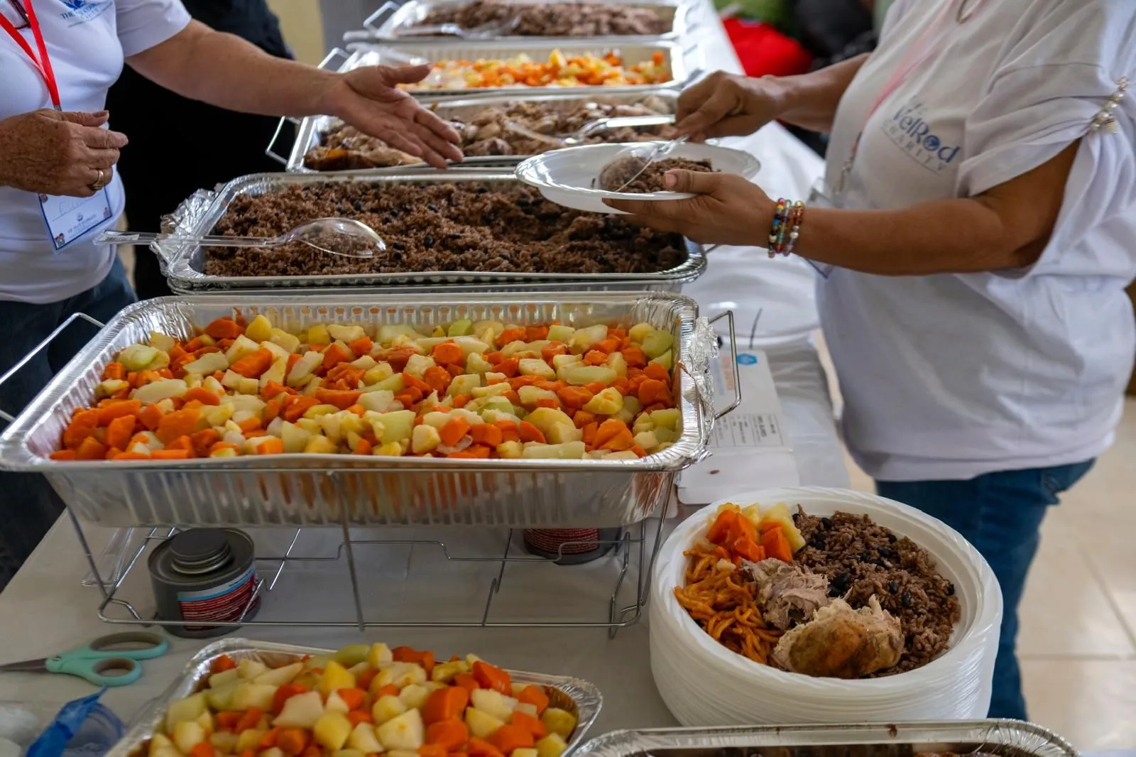 Volunteers serving hot meals to families