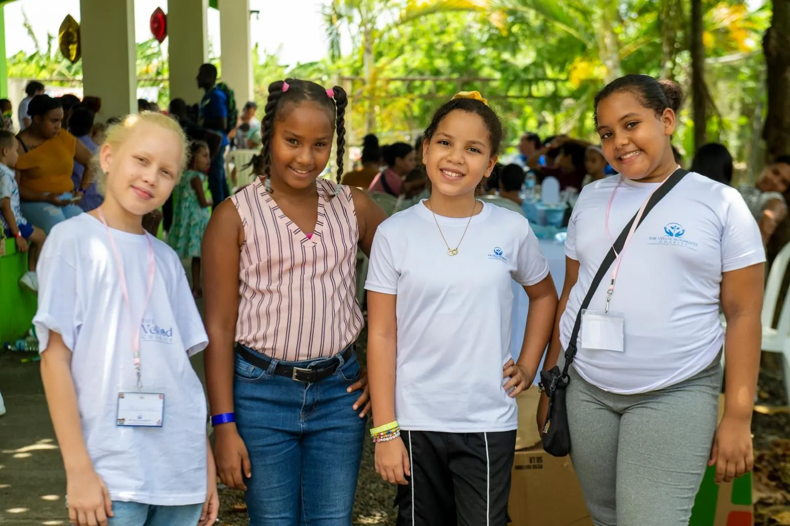 Four girls smiling at the Back-to-School Drive