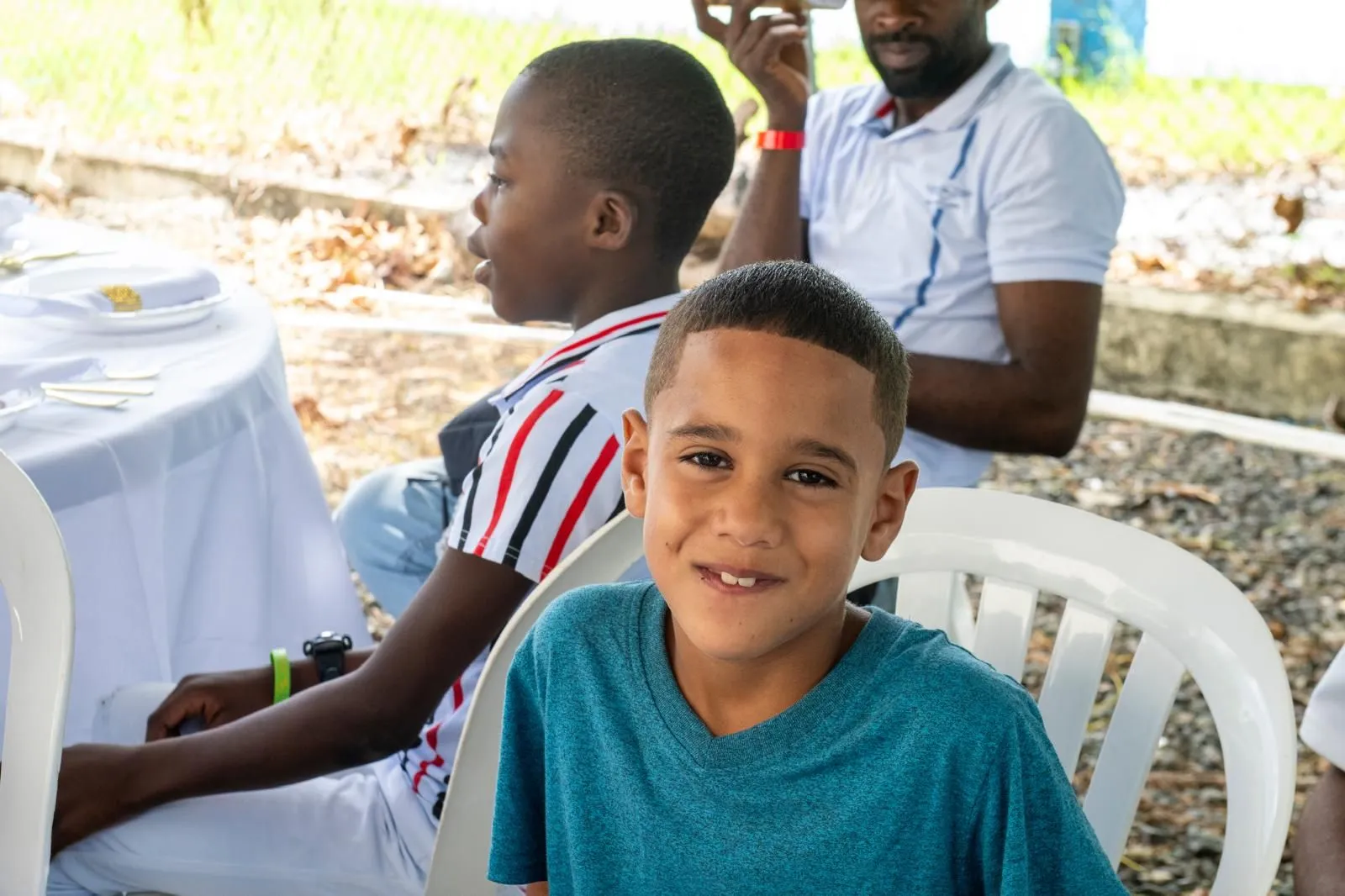 A young boy smiling at his table