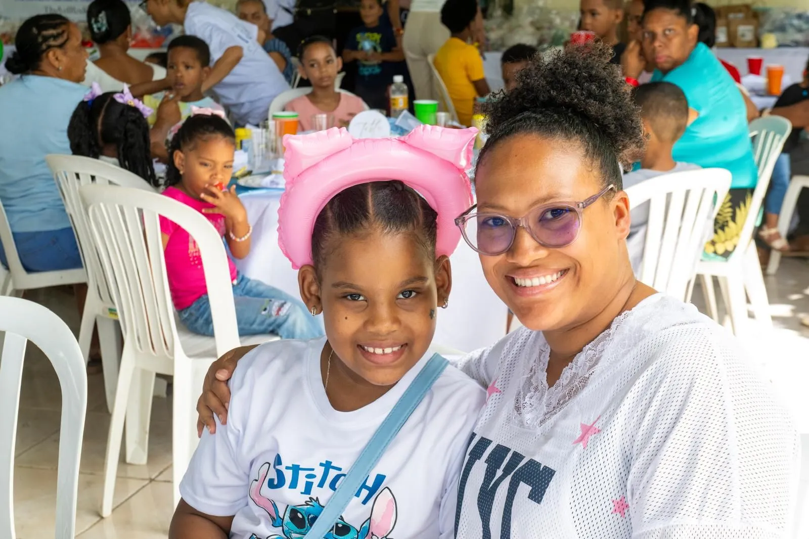 A girl and her mother smiling together
