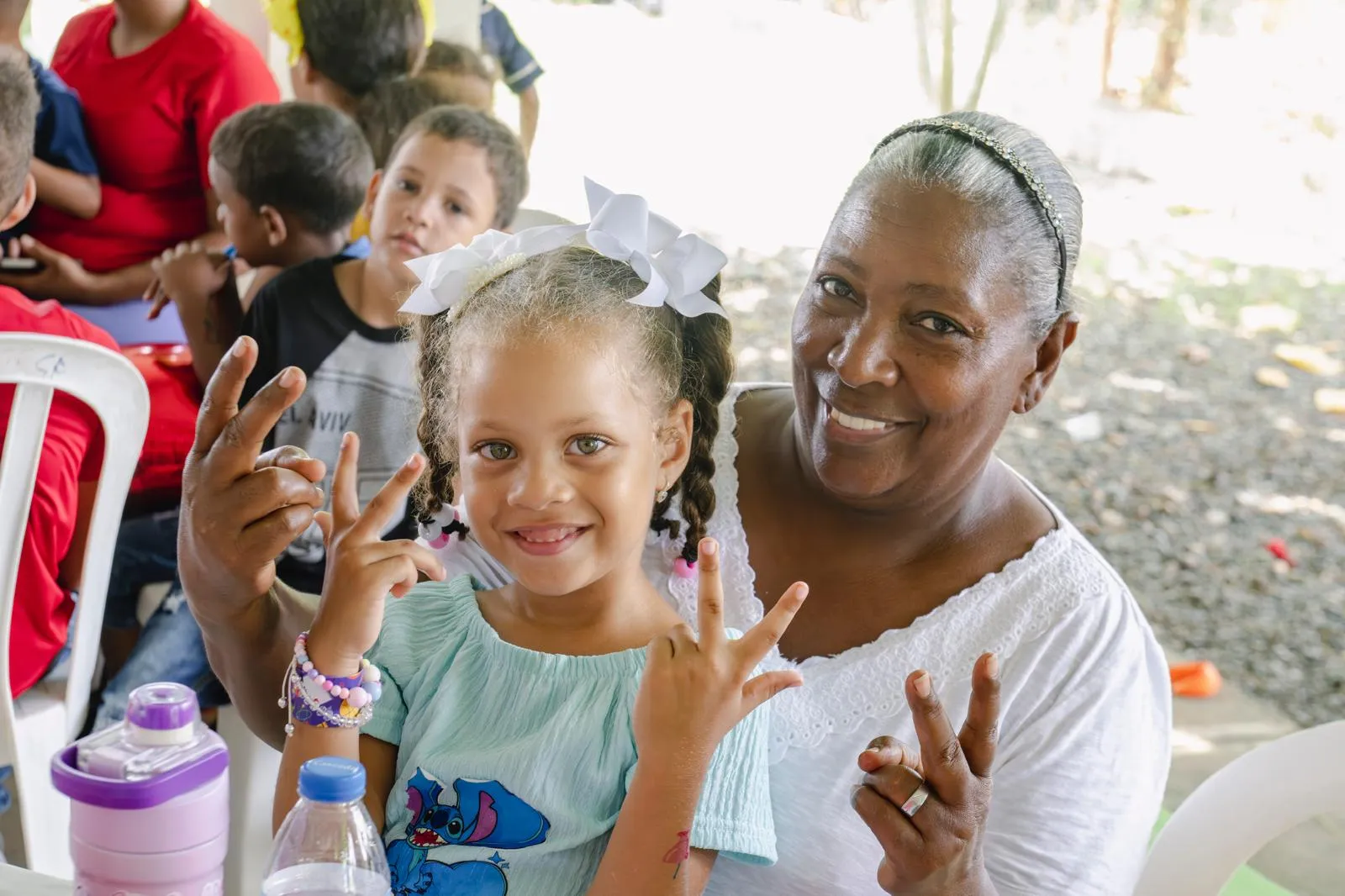 Girl and grandmother smiling at a VelRod event